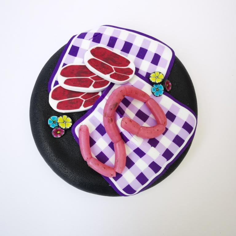 Square Dog glass treat Jar hand-decorated in New Zealand,  with  purple WOOF on the front and a polymer clay decorated air-tight lid, including a purple tablecloth, miniture sausages and steak as a gift for that special dog