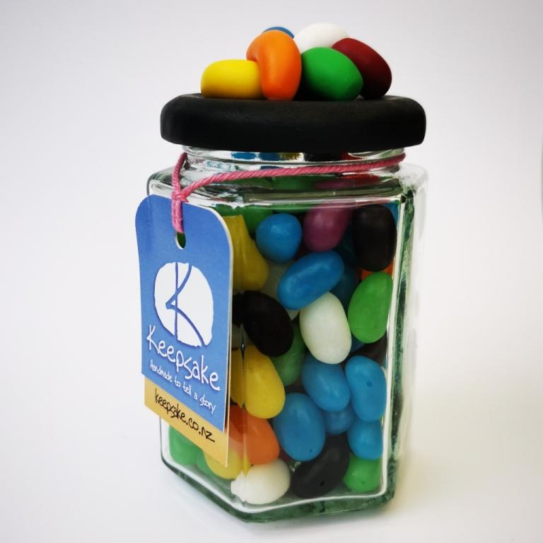 270ml glass hexagonal lolly jar hand-decorated in New Zealand, with  an air-tight lid decorated with polymer clay jelly beans. Filled with jelly beans