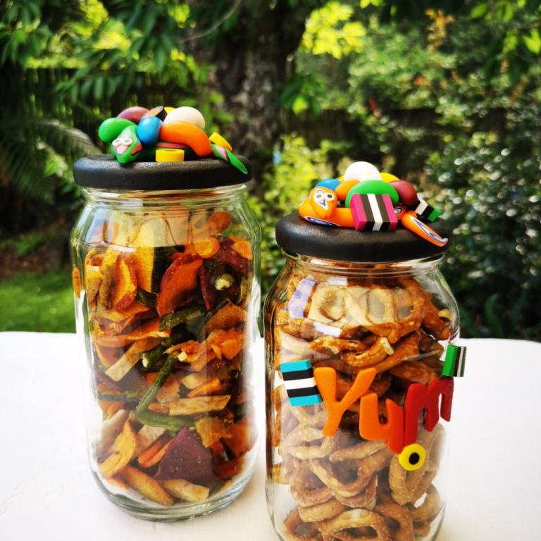 Extra-large glass treat jar hand-decorated in New Zealand, with an air-tight lid decorated with colourful polymer clay licorice allsorts, jelly beans and a pink snake, and with polymer clay YUM on the side. Perfect for the whole family or as a gift for Nana or Granddad.