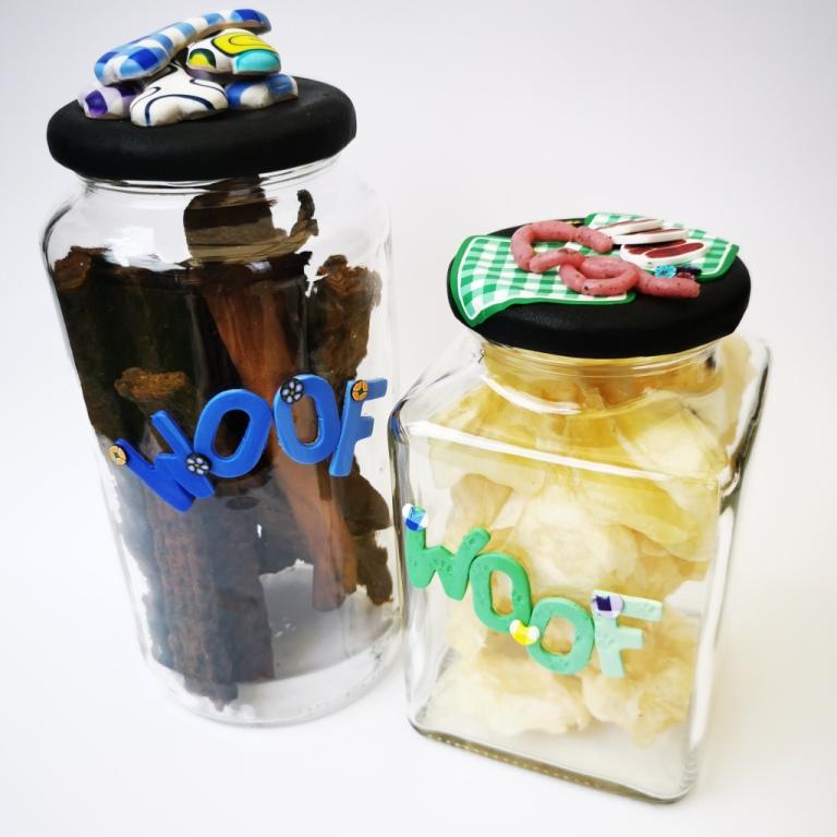 Round Dog glass treat Jar hand-decorated in New Zealand,  with a pile of  funky brightly decorated polymer clay bones on the air-tight lid, ideal as a gift for that special dog