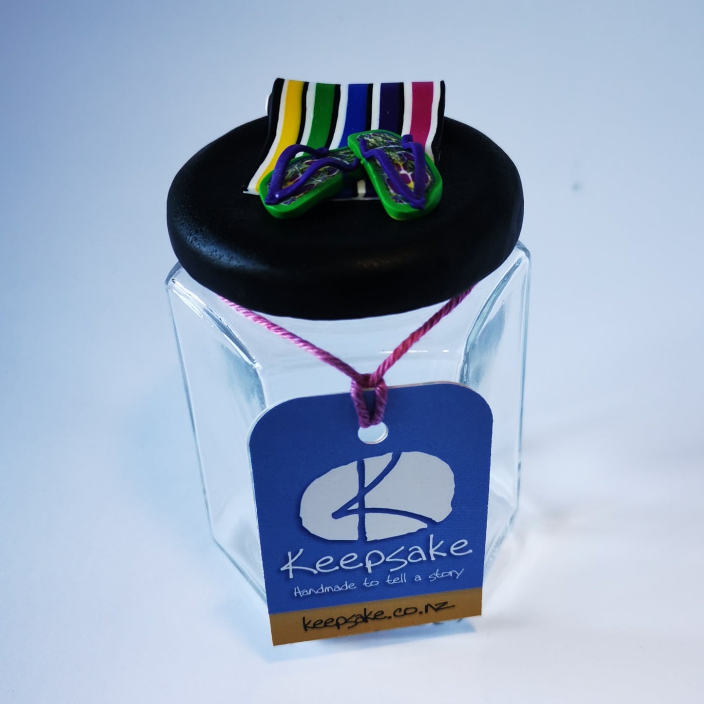 270ml glass hexagonal  jar and lid hand-decorated in New Zealand, with  an air-tight lid decorated with polymer clay beach towel, jandals and sunglasses. Ready to be filled with fudge, sweets or other treasures.