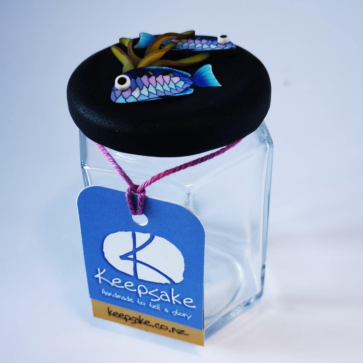 185ml glass hexagonal  jar and lid hand-decorated in New Zealand, with  an air-tight lid decorated with polymer clay snapper fish and kelp. Ready to be filled with kelp powder, sweets or other treasures.