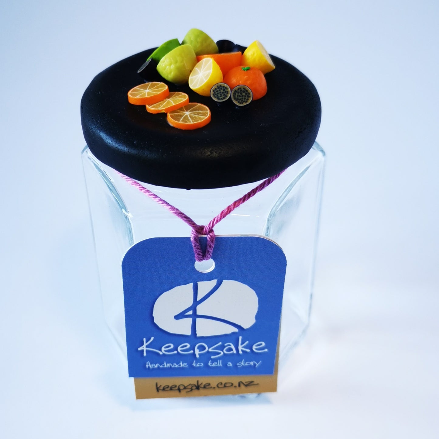 185ml glass hexagonal  jar and lid hand-decorated in New Zealand, with  an air-tight lid decorated with miniture oranges, lemons, limes and passionfruit. Ready to be filled with jam, marmalaide, sweets or other treasures.