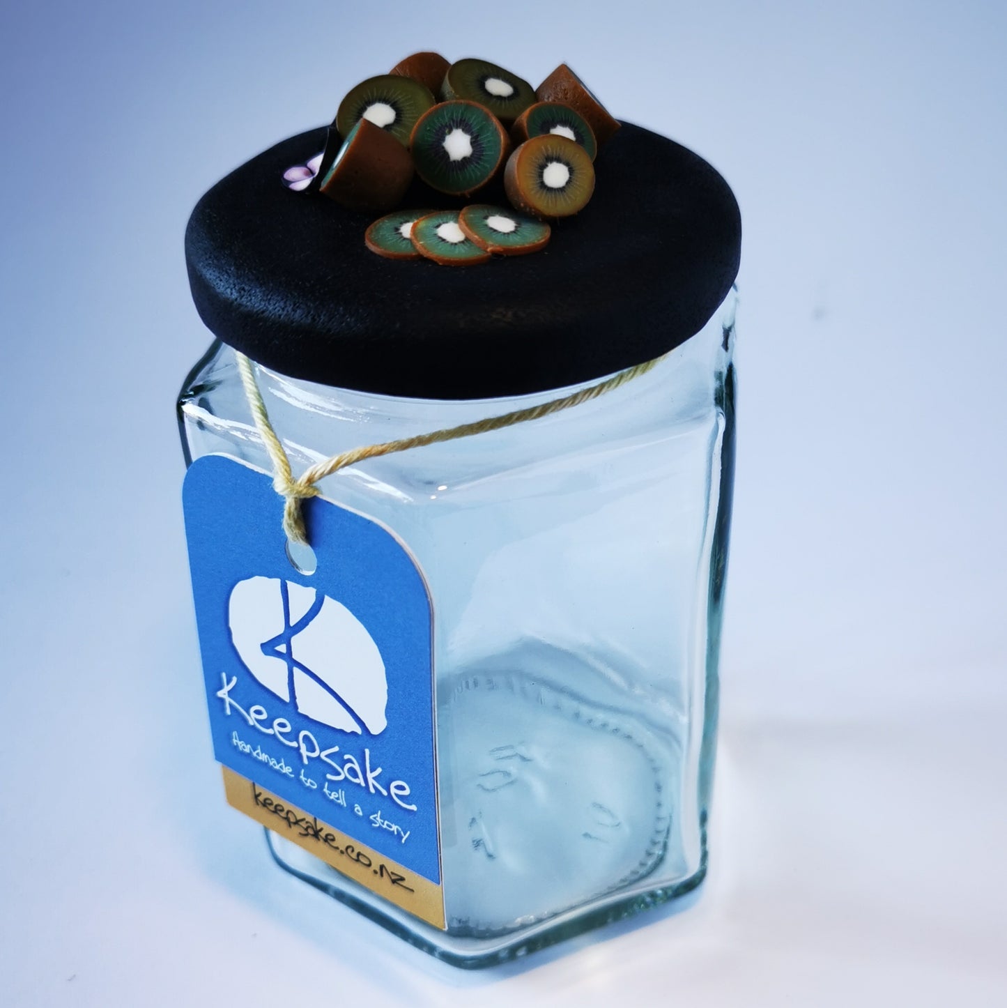 270ml glass hexagonal  jar and lid hand-decorated in New Zealand, with  an air-tight lid decorated with miniture polymer clay kiwifruit.  Ready to be filled with jam, sweets or other treasures.