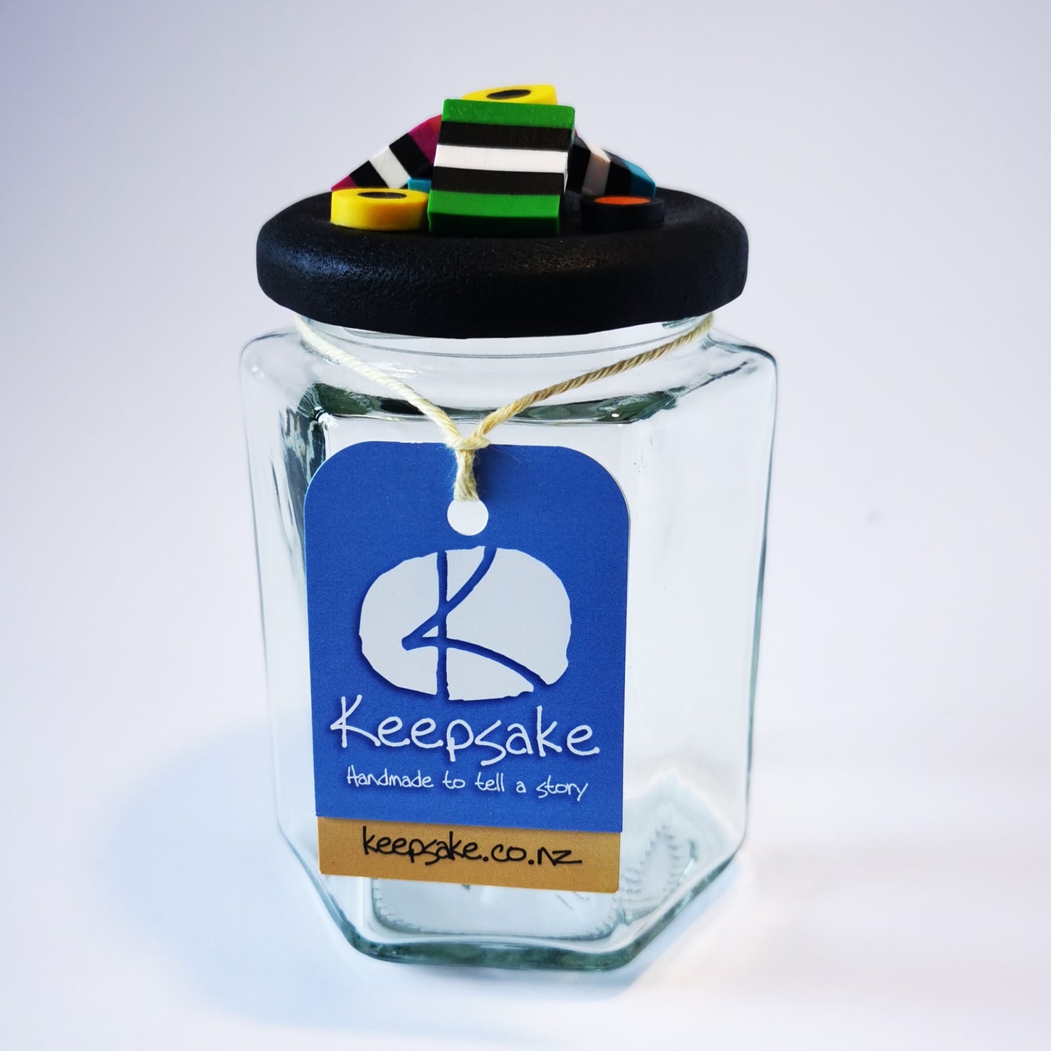 270ml glass hexagonal  jar and lid hand-decorated in New Zealand, with  an air-tight lid decorated with polymer clay licorice allsorts. Ready to be filled withlicorice allsorts, sweets or other treasures.