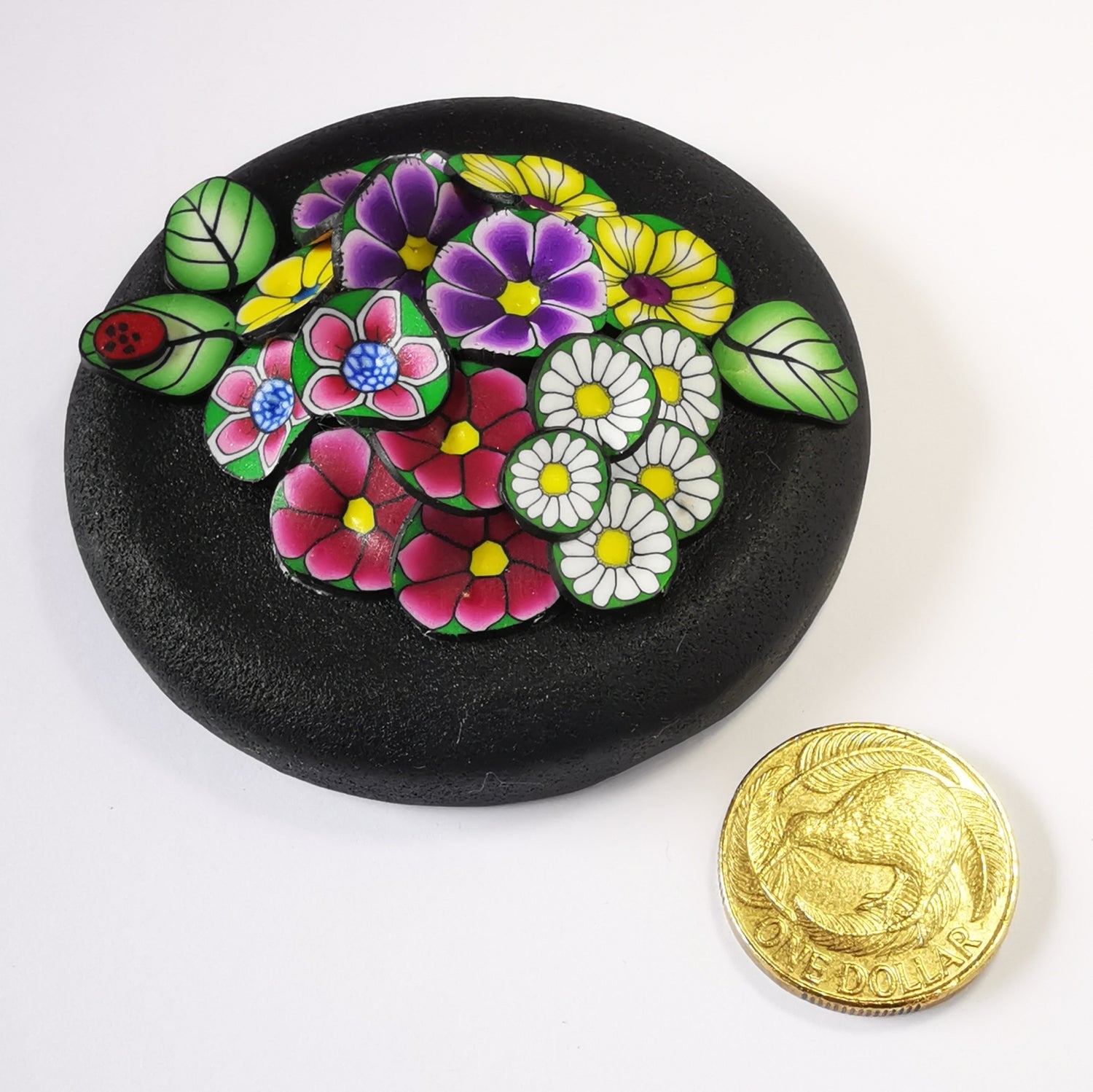 270ml glass hexagonal lolly jar hand-decorated in New Zealand, with  an air-tight lid decorated with colourful polymer clay flowers. Filled with flower jube sweets.