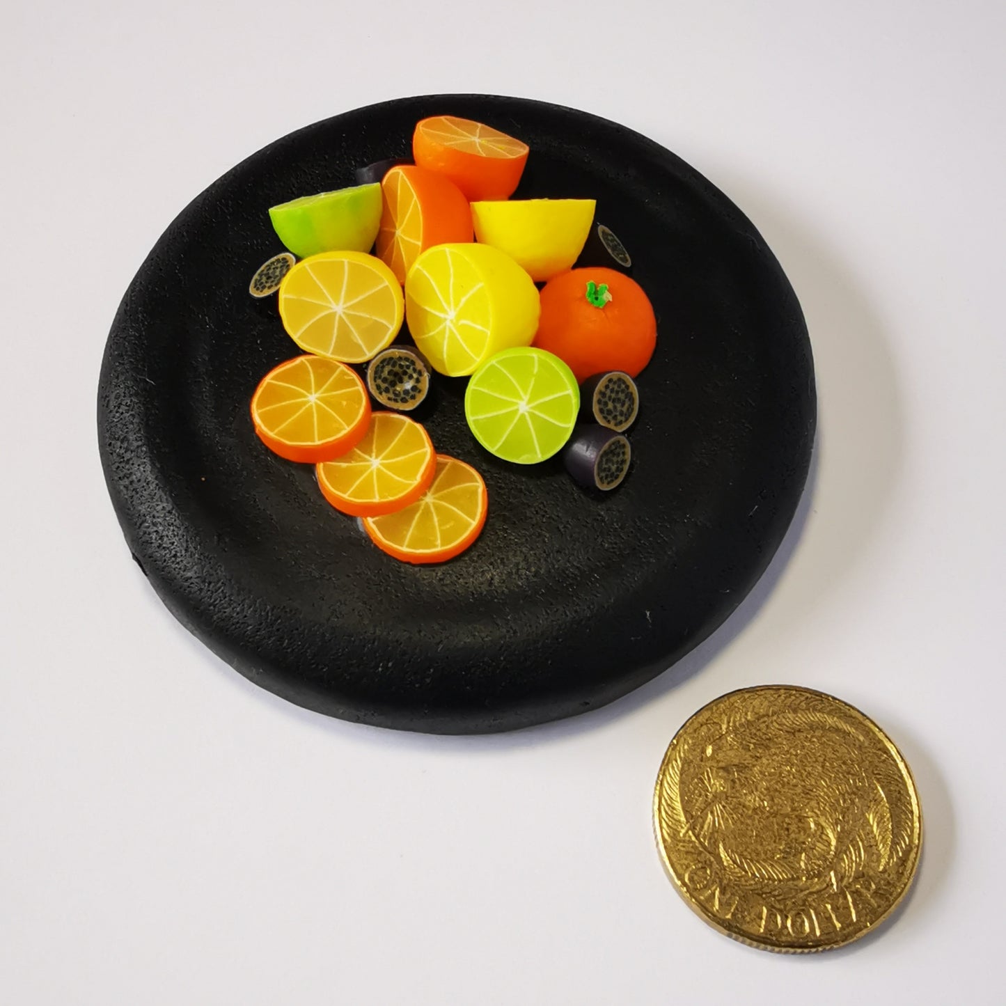 270ml glass hexagonal lolly jar hand-decorated in New Zealand, with  an air-tight lid decorated with miniture polymer clay  oranges, lemons, limes and passionfruit. Filled with orange and lemon jubes (jelly lollies)