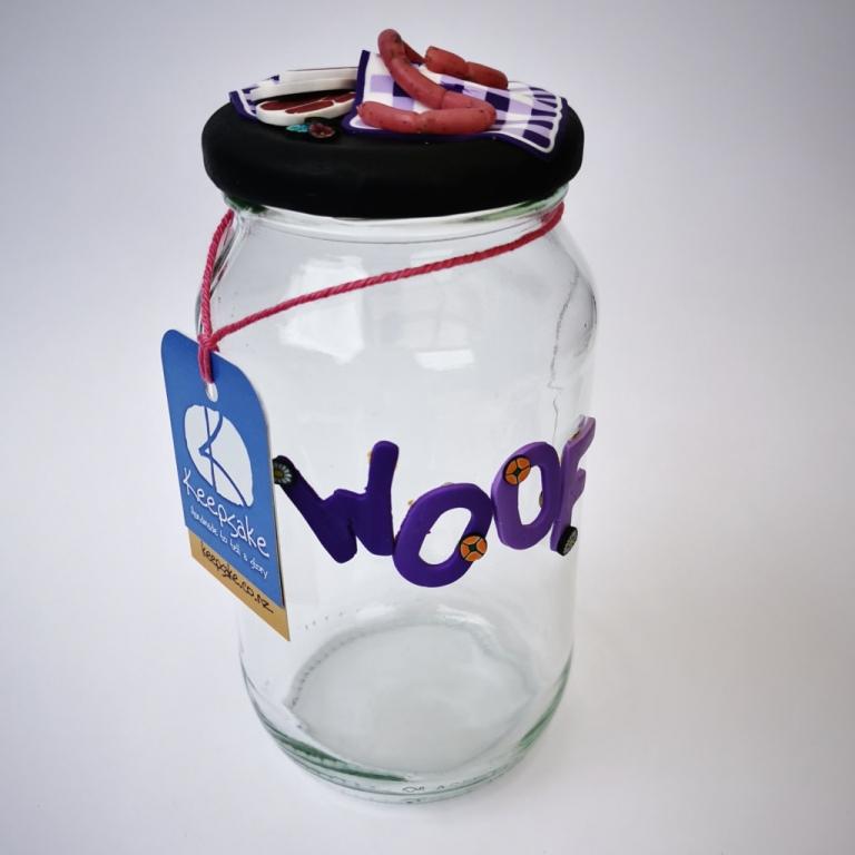 Round Dog glass treat Jar hand-decorated in New Zealand,  with  purple WOOF on the front and a polymer clay decorated air-tight lid, including a purple tablecloth, miniture sausages and steak as a gift for that special dog