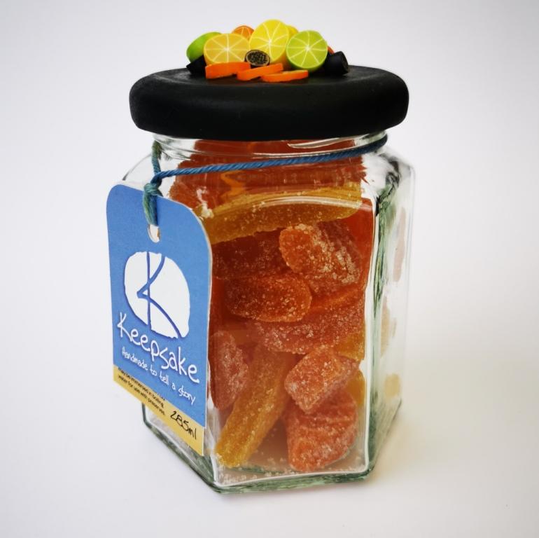 270ml glass hexagonal lolly jar hand-decorated in New Zealand, with  an air-tight lid decorated with miniture oranges, lemons, limes and passionfruit. Filled with orange and lemon jubes (jelly lollies)