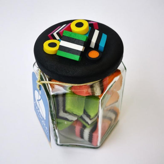 270ml glass hexagonal lolly jar hand-decorated in New Zealand, with  an air-tight lid decorated with polymer clay licorice allsorts. Filled with licorice allsorts.
