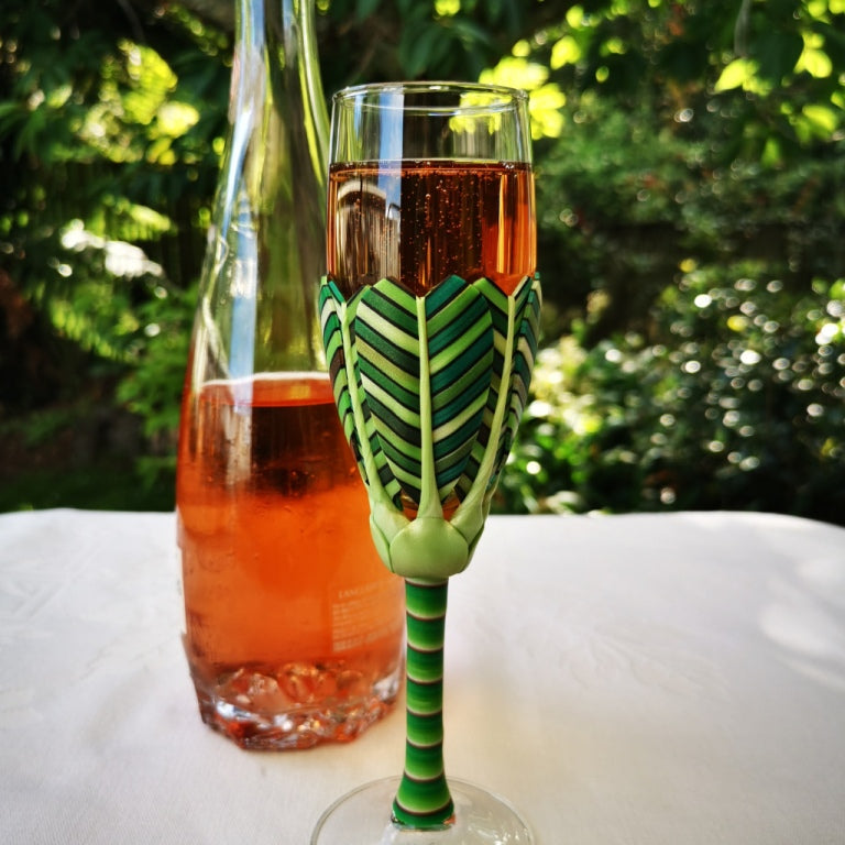 Champagne flute wine glass hand-decorated in New Zealand,  with  polymer clay, inspired by the New Zealand Nikau palm in shades of green, for a gift, wedding or special birthday.
