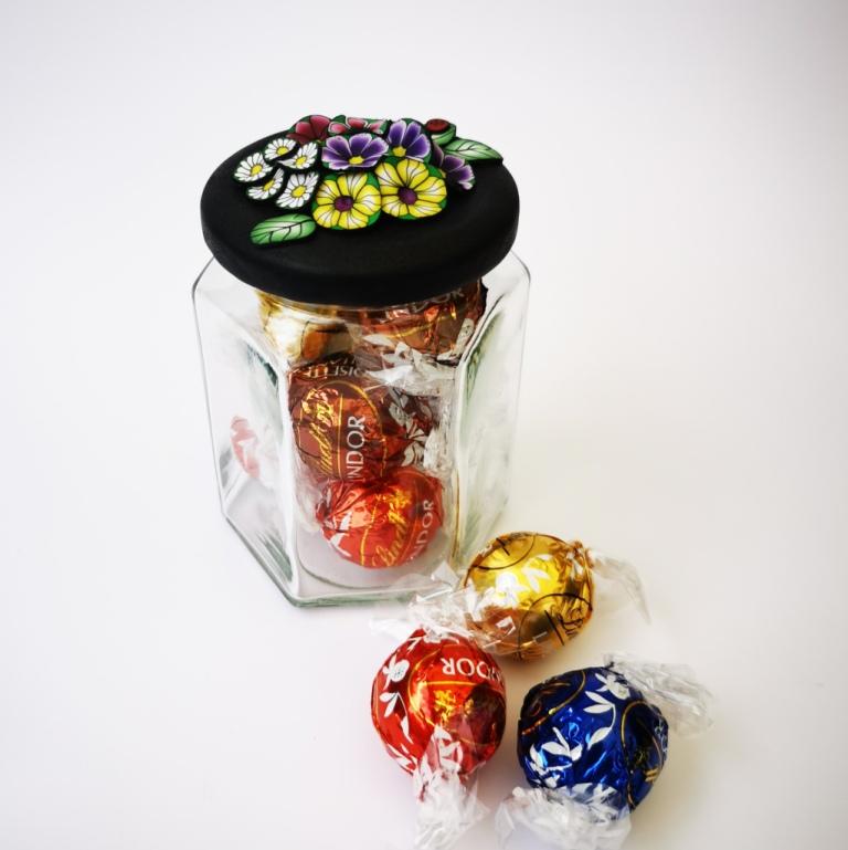 Upcycle your jar with an air-tight lid, hand-decorated in New Zealand. Decorated with colourful polymer clay flowers. Standard fitting  (63mm) so it fits jars you have at home. Gift boxed in an attractive matchbox.