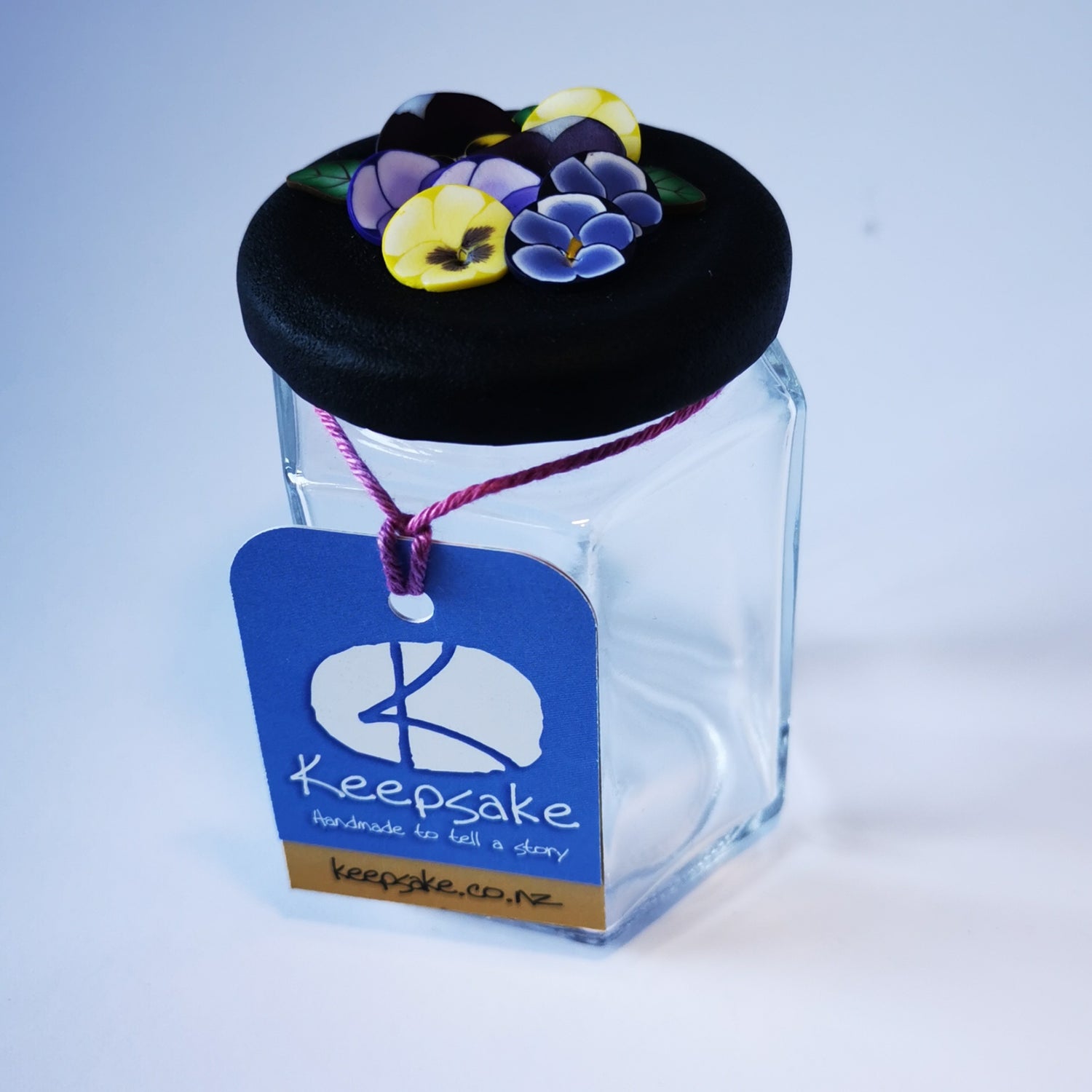 185ml glass hexagonal  jar and lid hand-decorated in New Zealand, with  an air-tight lid decorated with polymer clay pansies. Ready to be filled with fudge, sweets or other treasures.