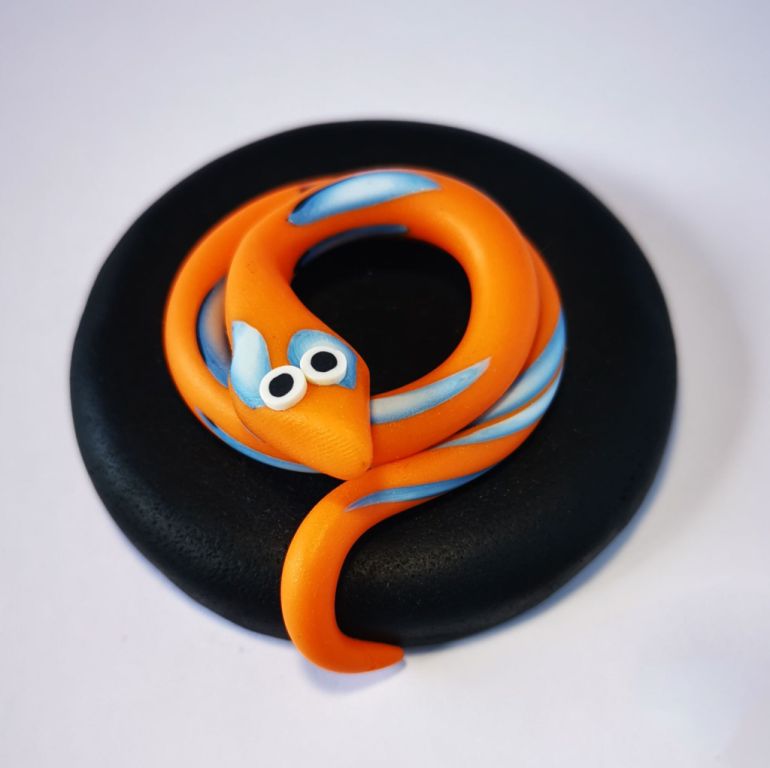 270ml glass hexagonal lolly jar hand-decorated in New Zealand, with  an air-tight lid decorated with a orange polymer clay snake. Filled with snake lollies