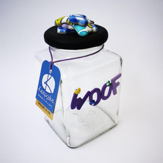Square Dog glass treat Jar hand-decorated in New Zealand,  with a pile of  funky brightly decorated polymer clay bones on the air-tight lid, ideal as a gift for that special dog